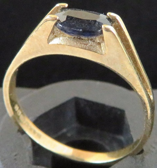 Ring marked .375 (9K) with blue stone. Approx 1.4 grams.