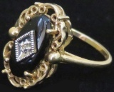 Ring marked 10K with black & clear stones. Approx 2.3 grams.