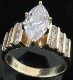 Ring marked 10K with clear stones. Approx 5.8 grams.