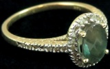 Ring marked 14K with light green & clear stones. Approx 2.3 grams.