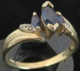 Ring marked 10K with blue & clear stones. Approx 2.5 grams.