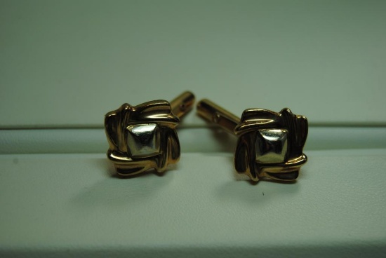 Gold cuff links.