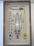 Three beaded necklaces, two with turtles and one with floral motif