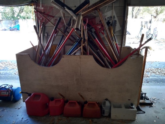 Wooden Storage box with various tools (rakes, shovels, brooms, etc.)
