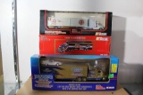 Three 1:64 Scale Die Cast Transporters, one is a bank