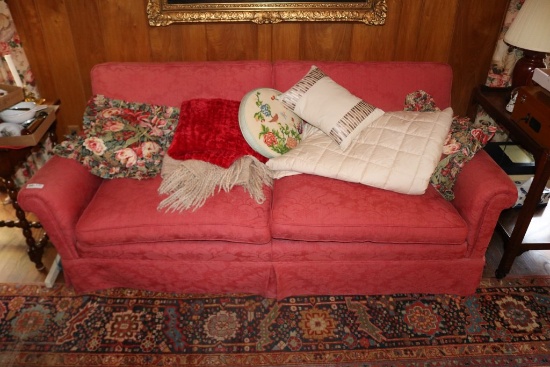 Red Upholstered Two Cushion Sofa and a Matching Swivel Chair