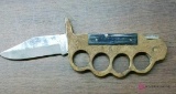 Brass knuckles with blade