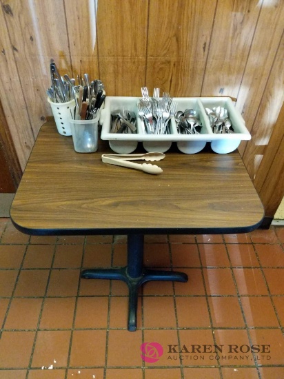 Square table with silverware and holder