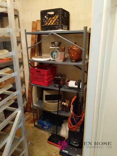 Metal shelving unit with contents and vacuum cleaner