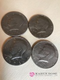 Four Kennedy half dollars