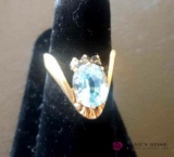 Ladies 14 karat gold ring with blue stone