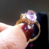 Ladies 14 karat gold ring with purple stone