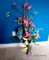 Artificial flower arrangement in metal vase