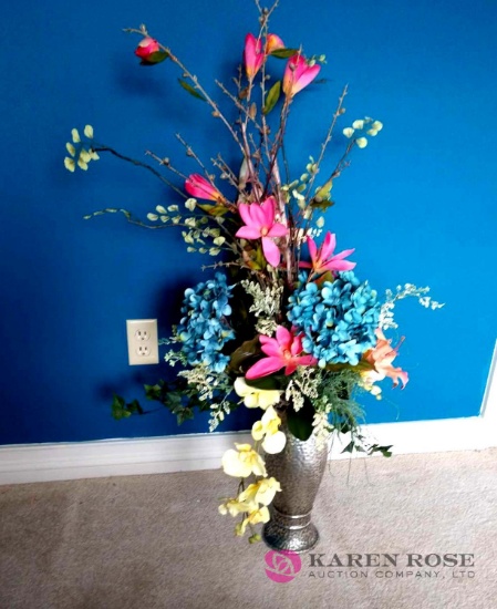 Artificial flower arrangement in metal vase