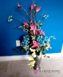 Artificial flower arrangement in metal vase