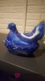 Blue and white nesting hen