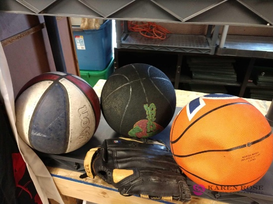 Three basketballs and a baseball mitt