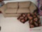 90 inch couch with pillows in basement