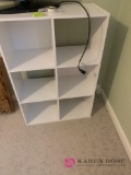 Two white cubicle shelves