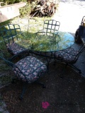 48 in glass top patio table with four chairs.c1