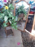 Mirror and silk plant in wicker stand