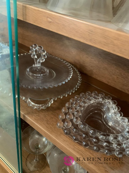 Shelf of clear glass dishes