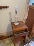 Small wooden nightstand and lamp