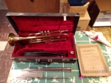 Vintage Bundy trumpet, music book, a music stand with case