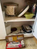 Contents of kitchen shelf crockpot blender