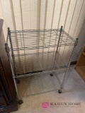 Three tier metal shelf on wheels plus cleaning supplies