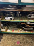 Contents of cabinet baking dishes pots and pans
