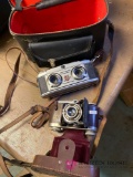 Two vintage cameras one stereo camera One regular