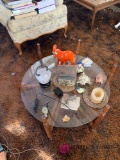 2 foot round glass coffee table and knickknacks