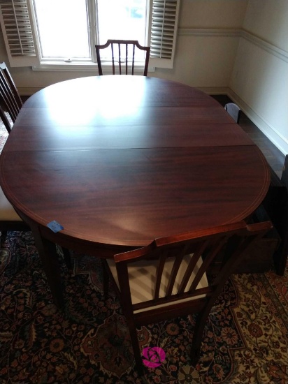 76 inch table by 54 inch. Table has six extra leafs. Table has five matching chairs and cart