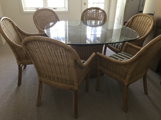 6 Ficks Reed chairs and 54 inch glass top wicker based table