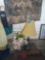 Short stand, brass lamp, wall tapestry and flower
