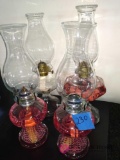 4 oil lamps with pink fluid