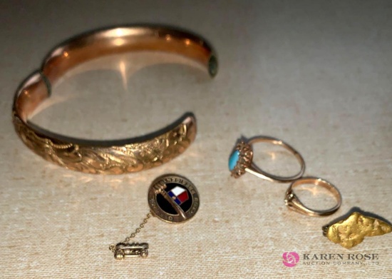 Gold colored bracelet and rings