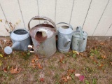 Four galvanized watering cans
