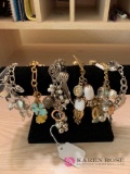 Six costume jewelry charm bracelets