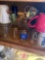 Kitchen cabinet lower left side of the sink coffee cups and drinking glasses