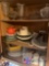 Kitchen cabinet three shelves of plates coffee cups and miscellaneous