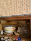 Kitchen shelf serving platters bowls water pitcher