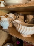 Kitchen shelf coffee cups tea cups cream and sugar bowl