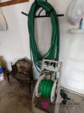 Garden hose caddy and extra hose