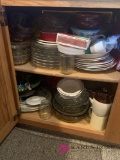 Kitchen cabinet right of dishwasher clear plates mugs jars and other miscellaneous