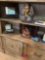 Two shelves of Decour picture frames candles books miscellaneous