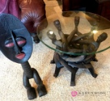 Round glass top table and wooden figure