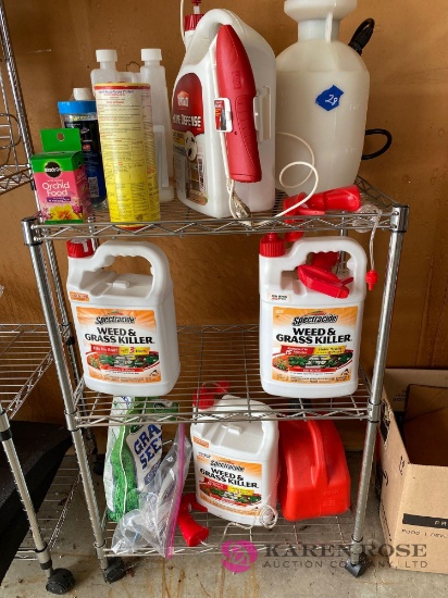 Assorted lawn chemicals and rolling cart