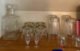 Shelf of drinking glasses shot glasses and miscellaneous